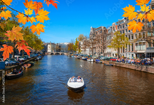 Traditional old buildings and and boats in Amsterdam, Netherlands