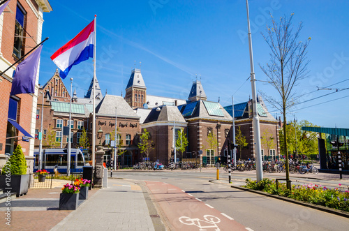 Netherlands flag and Rijksmuseum (National state museum), a popular touristic destination in Amsterdam, Netherlands
