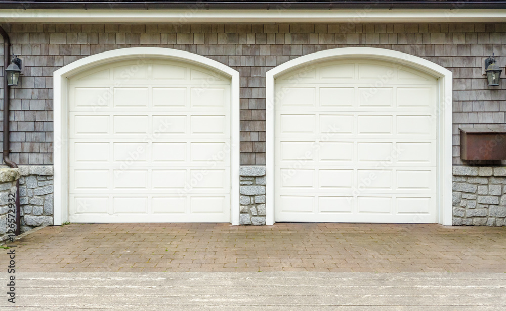 Fragment of a luxury house with a double garage door in Vancouver, Canada. Fragment of a luxury house with a double garage door in Vancouver, Canada.