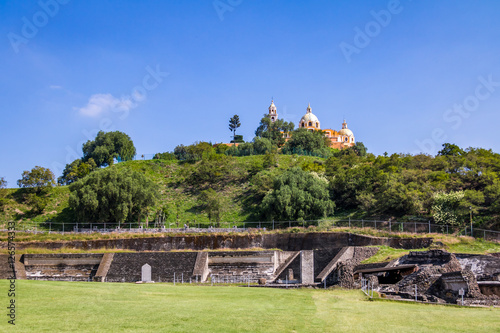 Ruins of Cholula pyramid with Church of Our Lady of Remedies at top of it - Cholula, Puebla, Mexico photo
