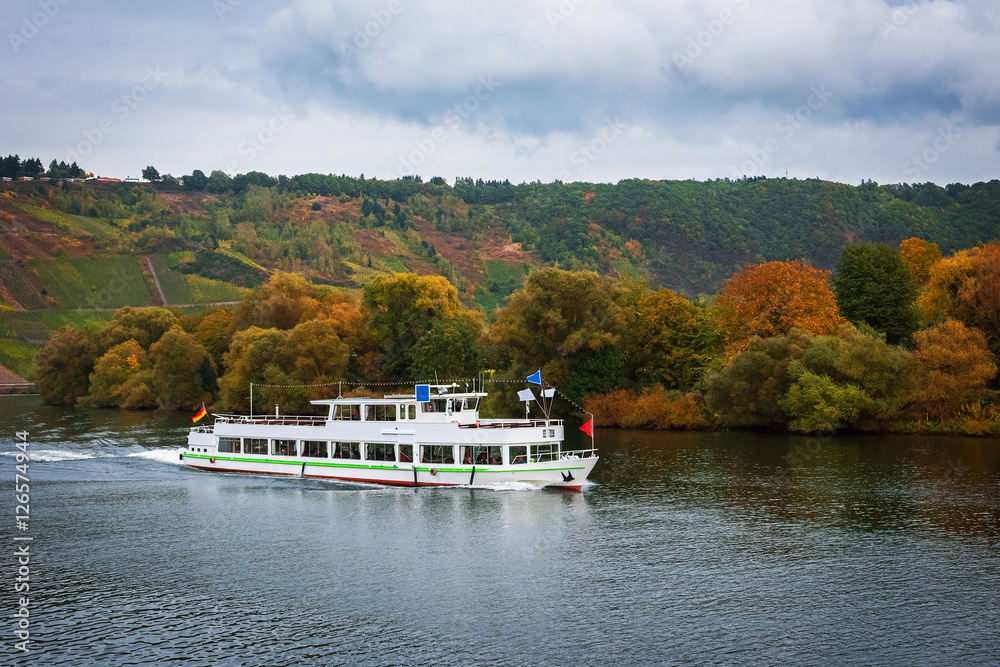 Pleasure boat on the Moselle River in autumn, Germany Pleasure boat on the Moselle River in autumn, Germany