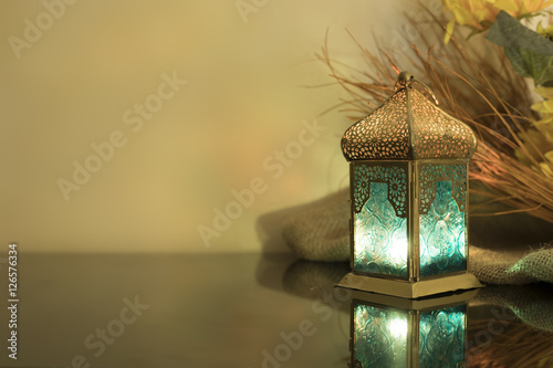Small Lantern with straw in background photo