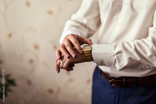 businessman clock clothes, businessman checking time on his wristwatch. men's hand with a watch, watch on a man's hand, the fees of the groom, wedding preparation, preparation for work, 
