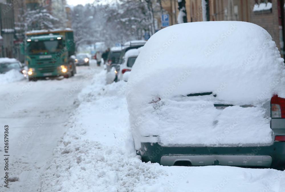 Snow chaos in the traffic. Cars covered with snow
