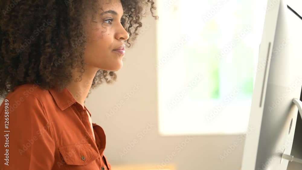 Cheerful businesswoman working on desktop computer