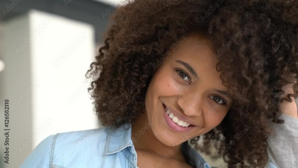 Attractive smiling mixed-race girl at home Attractive smiling mixed-race girl at home