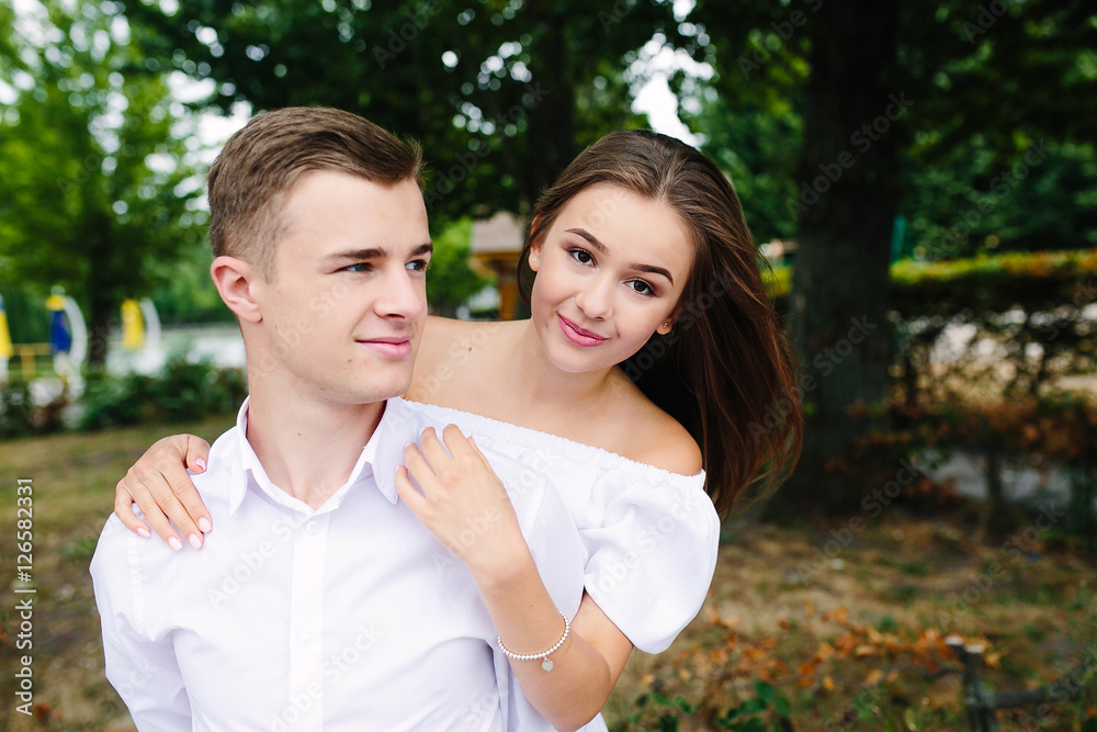 Young adult brunette man and woman in the park Young adult brunette man and woman in the park