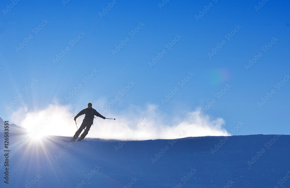 Man on ski is skiing on the snow during wonderful sunny day, best for winter extreme sports Man on ski is skiing on the snow during wonderful sunny day, best for winter extreme sports