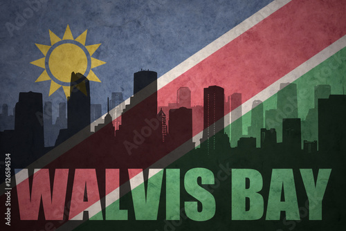 abstract silhouette of the city with text Walvis Bay at the vintage namibian flag