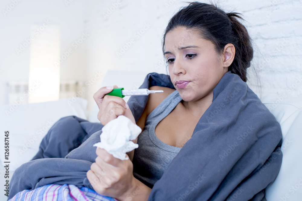young attractive hispanic woman lying sick at home couch in cold and flu in gripe disease symptom young attractive hispanic woman lying sick at home couch in cold and flu in gripe disease symptom