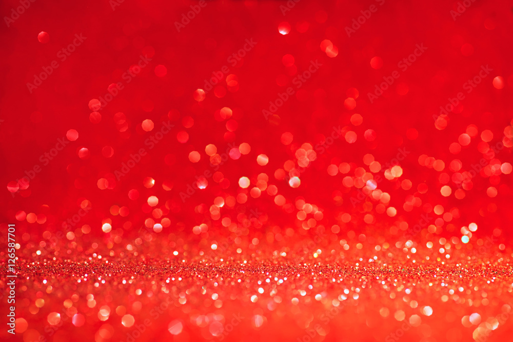 Red defocused background with flying glitters Red defocused background with flying glitters