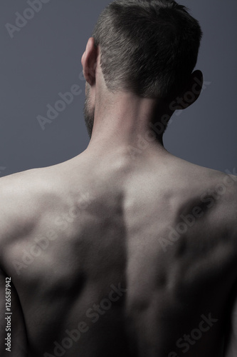 Art concept of natural male beauty. Back of slim man photo