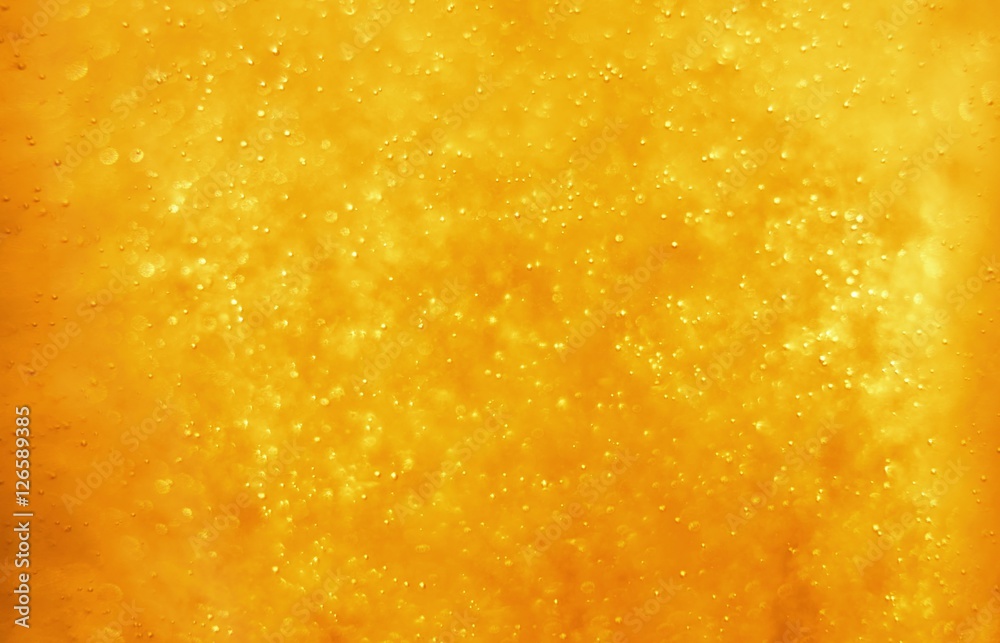 Bubbles floating in the liquid orange drink, abstract image. Bubbles floating in the liquid orange drink, abstract image.