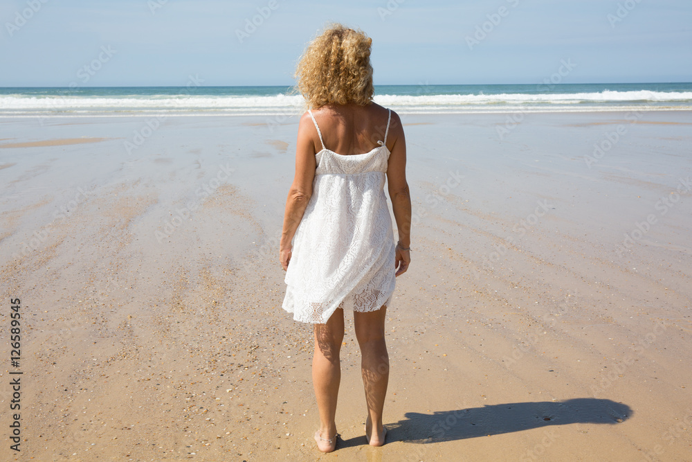 Beautiful woman on the beach, slim model, happy summer vacation