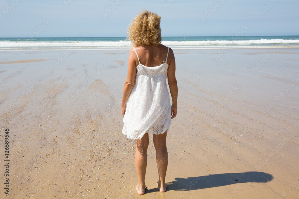 Beautiful woman on the beach, slim model, happy summer vacation Beautiful woman on the beach, slim model, happy summer vacation