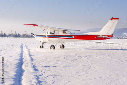 Small sports plane in winter at snow covered airport © asafaric