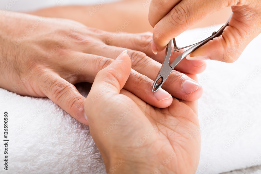 Manicurist Cutting Off The Cuticle From The Person's Fingers Manicurist Cutting Off The Cuticle From The Person's Fingers