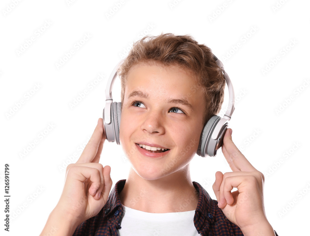 Fototapeta premium Boy listening music on light background