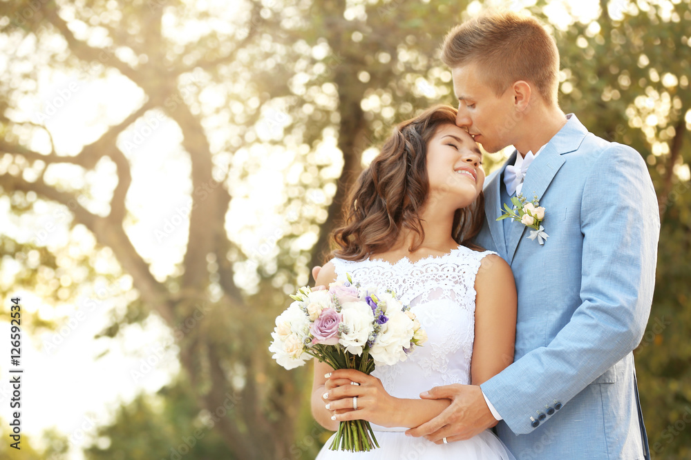 Portrait of beautiful wedding couple in park Portrait of beautiful wedding couple in park
