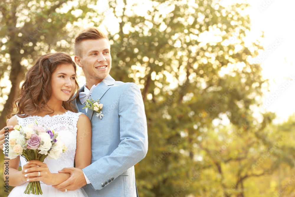 Portrait of beautiful wedding couple in park Portrait of beautiful wedding couple in park