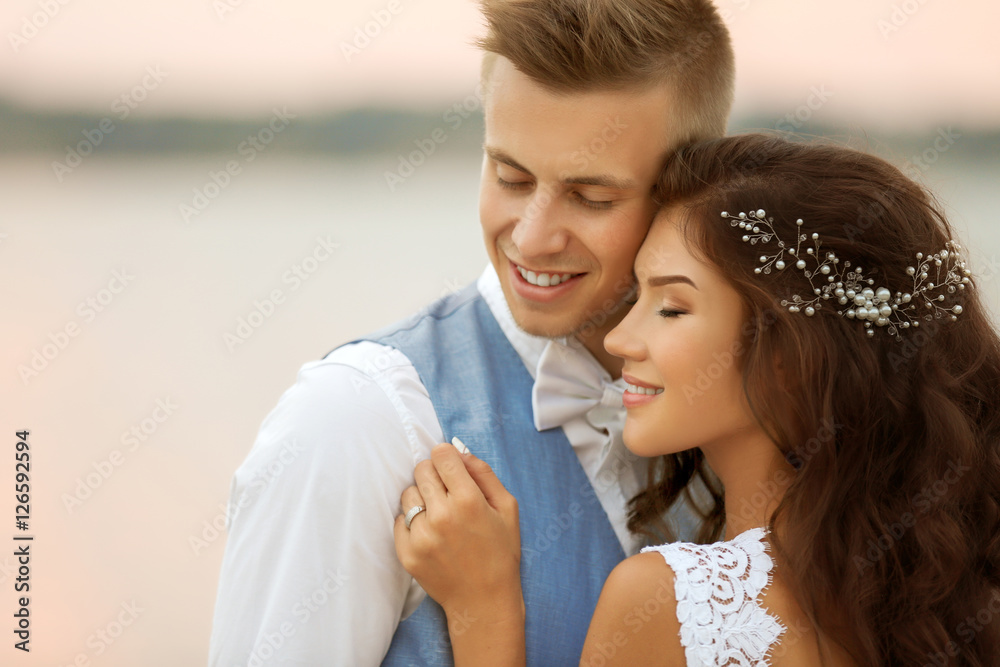 Portrait of beautiful wedding couple near river, close up view Portrait of beautiful wedding couple near river, close up view