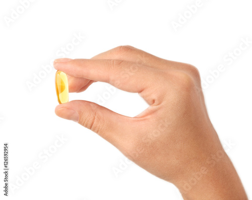 Woman holding Omega 3 fish oil capsule on white background