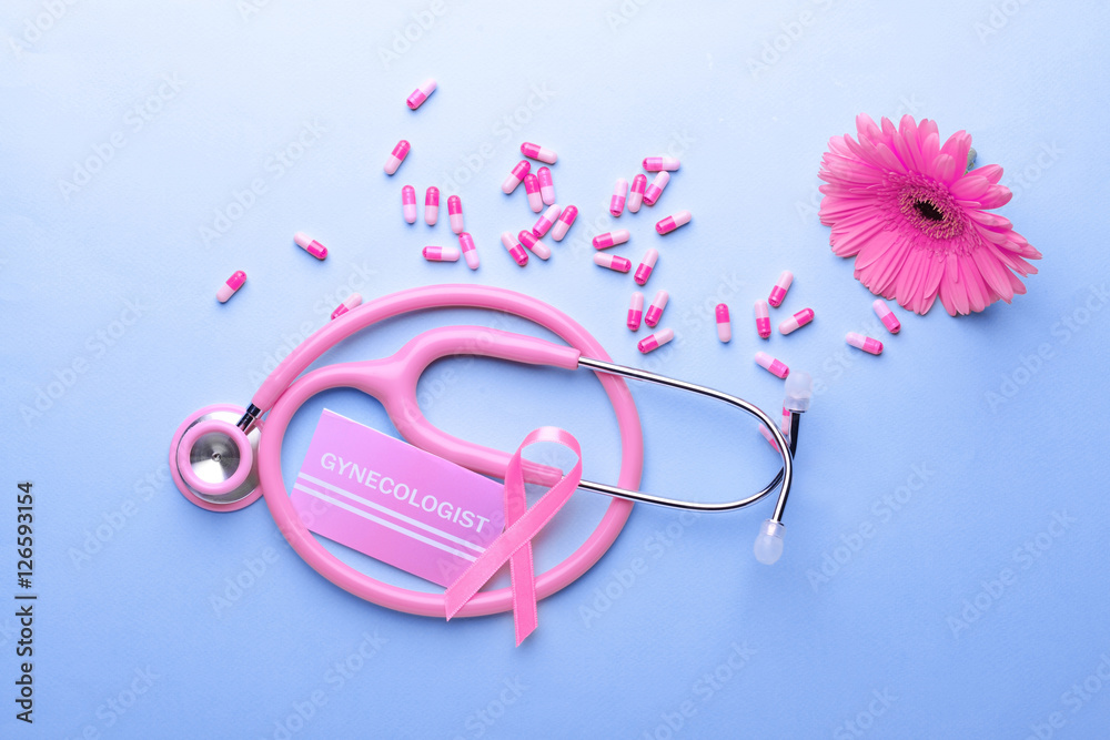 Business card with word GYNECOLOGIST, ribbon and stethoscope on blue background