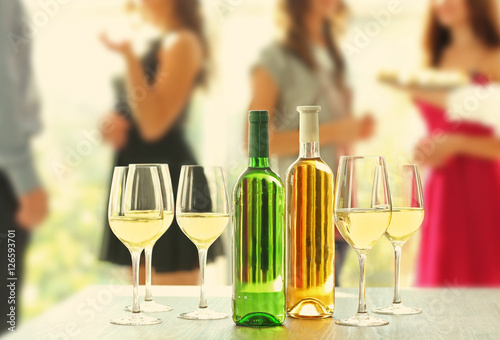 Bottles and glasses of whit...