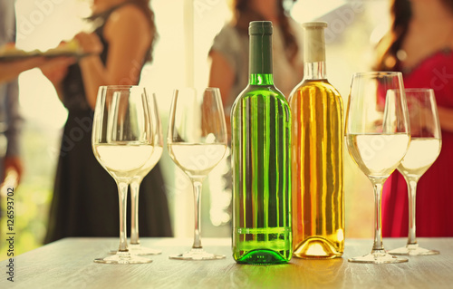Bottles and glasses of whit...