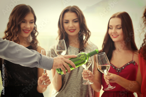 Man pouring white wine into...