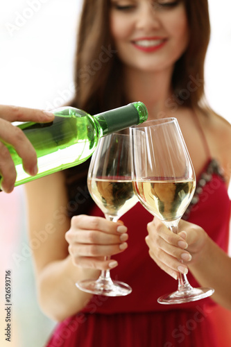 Man pouring white wine into...