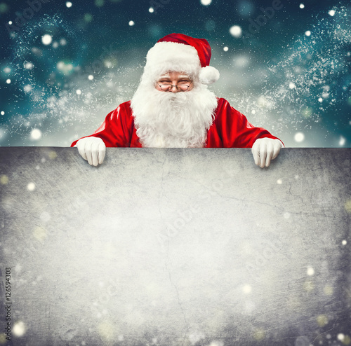 Santa Claus holding blank advertisement banner background with copy space for text