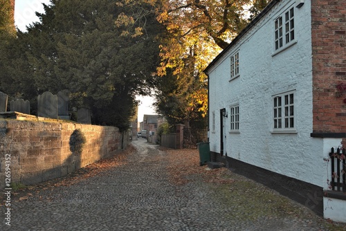 Dawn light through road towards old farm building