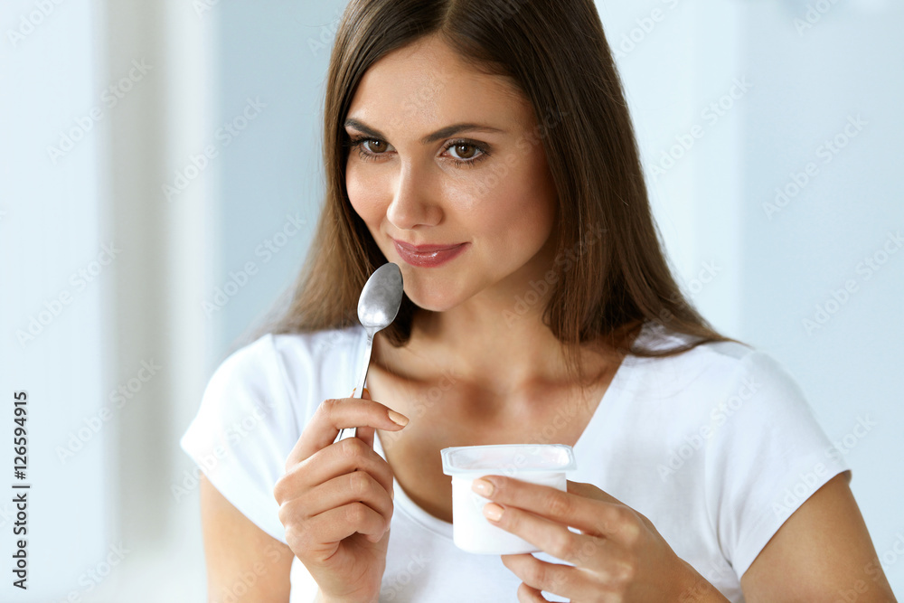 Healthy Nutrition. Beautiful Woman Eating Yogurt, Dairy Product Healthy Nutrition. Beautiful Woman Eating Yogurt, Dairy Product