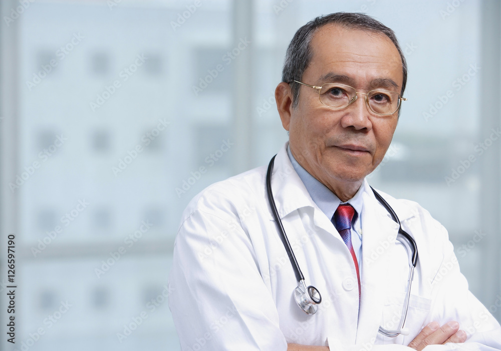 Doctor with arms crossed, looking at camera Doctor with arms crossed, looking at camera