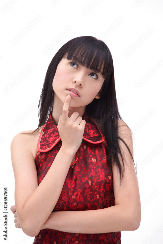 Young woman, finger on chin, looking up Young woman, finger on chin, looking up