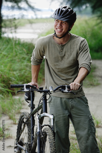 Man with bicycle, outdoors