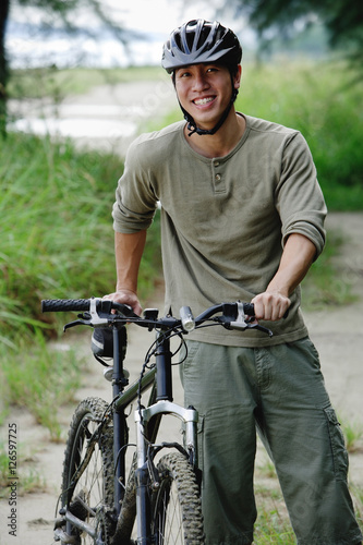 Man with bicycle, outdoors, portrait