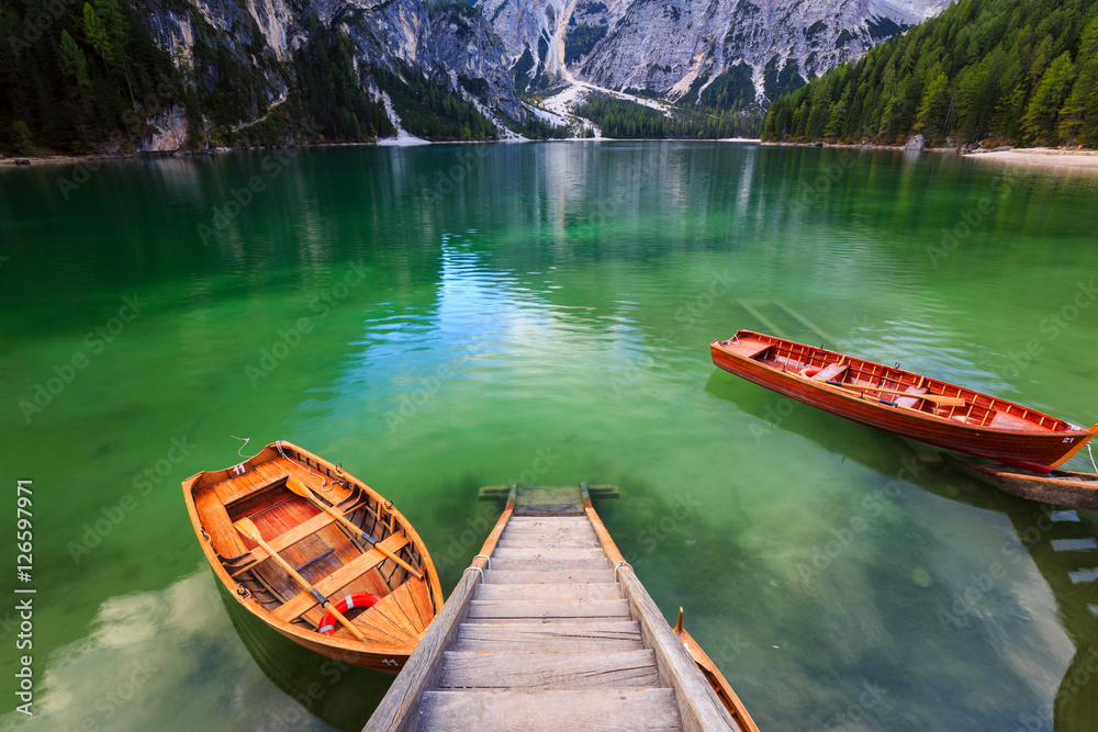 Boats on the Braies Lake ( Pragser Wildsee ) in Dolomites mounta