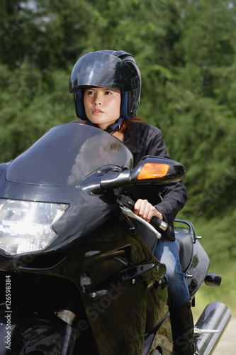 Young woman riding motorbike