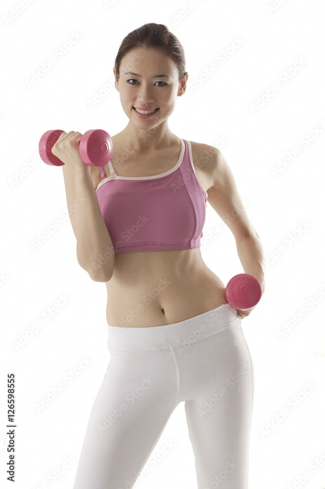 Woman lifting weights, looking at camera, smiling Woman lifting weights, looking at camera, smiling