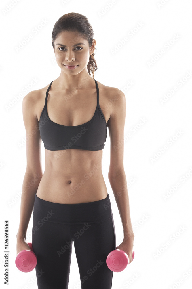 Woman holding weights, looking at camera Woman holding weights, looking at camera