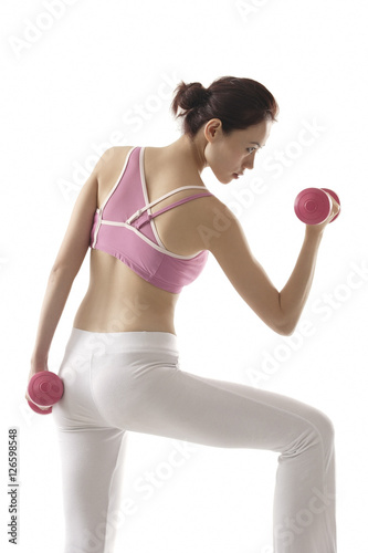 Woman with back to camera, lifting weights