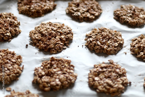 Simple cookies prepared with three ingredients: oatmeal, mashed bananas and cocoa powder, before baking. Top view, selective focus.
