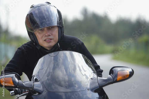 Man wearing helmet and riding motorcycle © Alexander