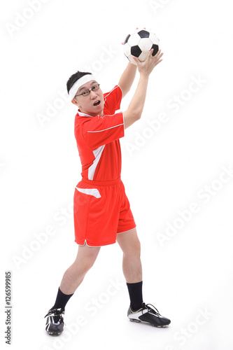 Fototapeta Naklejka Na Ścianę i Meble -  Man in soccer uniform holding soccer ball