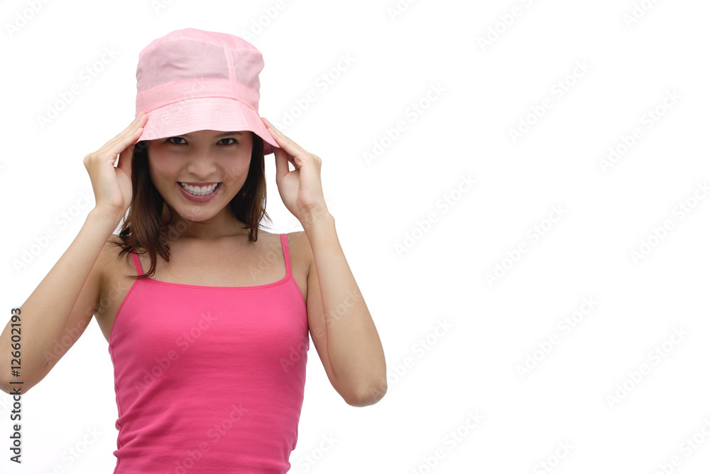 Young woman wearing pink hat and smiling at camera Young woman wearing pink hat and smiling at camera