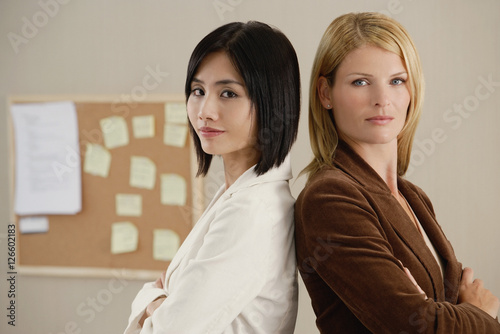 Two female colleagues look at the camera together