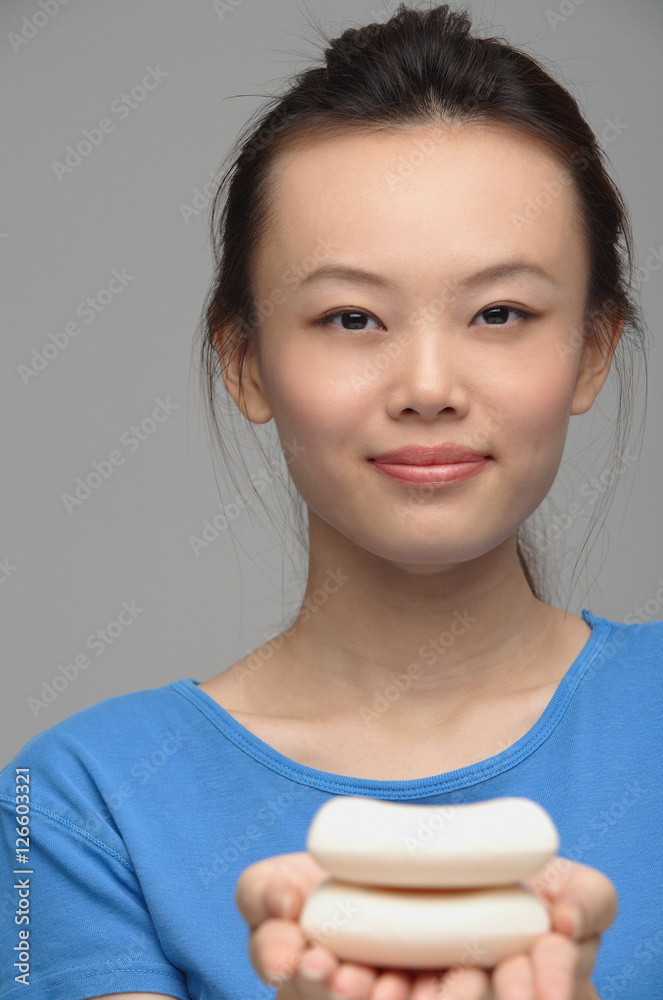 Young woman with soap smiling at camera