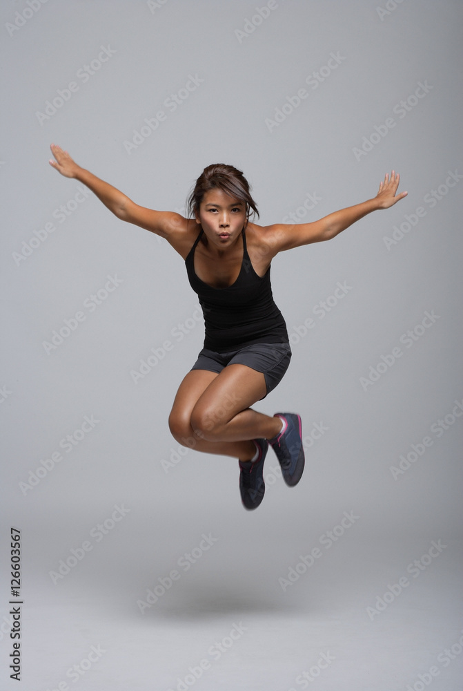 Young woman jumping up